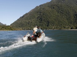 MOVING UP THE YELCHO RIVER -- BOATS WITH MOTORS ARE ESSENTIAL DO TO FEW ROADS IN THE AREA.  BUT IS EQUALLY AS IMPORTANT TO HAVE A LIGHT, SAFE, QUIET BOAT TO FLOAT THE TREE TRUNKS ALONG THE BANKS