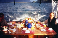 BREAKFAST ON PUMA I -NOTE SKIFFS BEING TOWED BEHIND