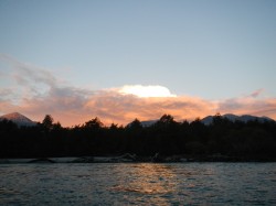 SUN SHINING ON CLOUDS TO THE WEST JUST BEFORE SUNSET ON THE YELCHO RIVER