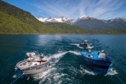 CUSTOMIZED LAKE SKIFFS BEING TOWED BEHIND PUMA II