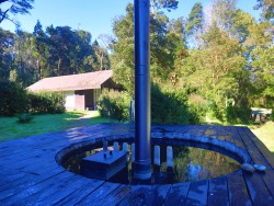 HOT TUB ON THE DECK AT PUMA LODGE WITH ONE OF THE PRIVATE CABANAS IN BACKGROUND