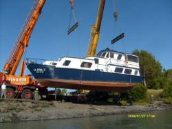 PUMA II BEING LOADED ON TRUCK AT MOUTH OF YELCHO RIVER FOR TRANSPORT TO THE LAKE