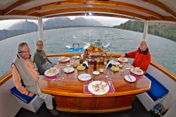 DINING AREA-PUMA II -NOTE SKIFFS IN TOW