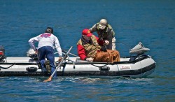 SWIMS WITH RAINBOWS (CAPTAIN BILL CURTIS)-BILL AND PABLO GETTING BACK IN THE BOAT